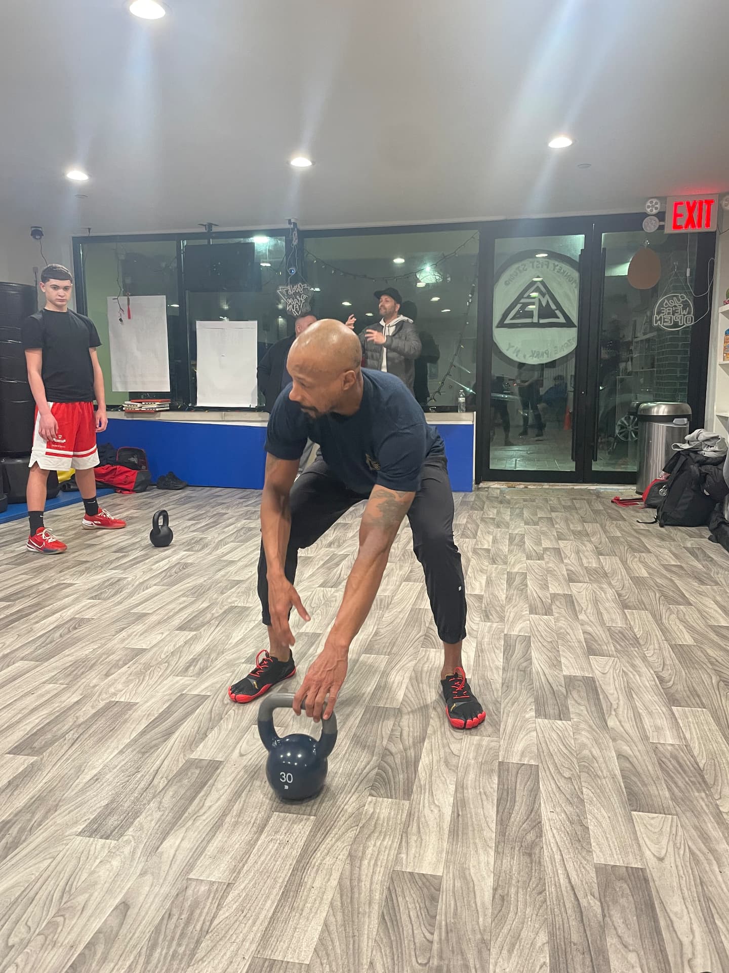 Coach demonstrating a kettlebell hinge setup