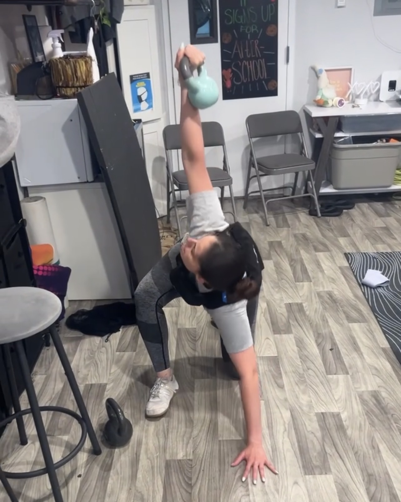 Athlete holding a bottoms-up kettlebell windmill overhead
