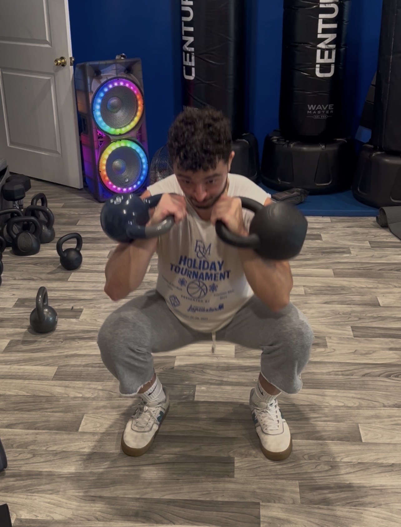 Athlete in a deep double kettlebell front rack squat