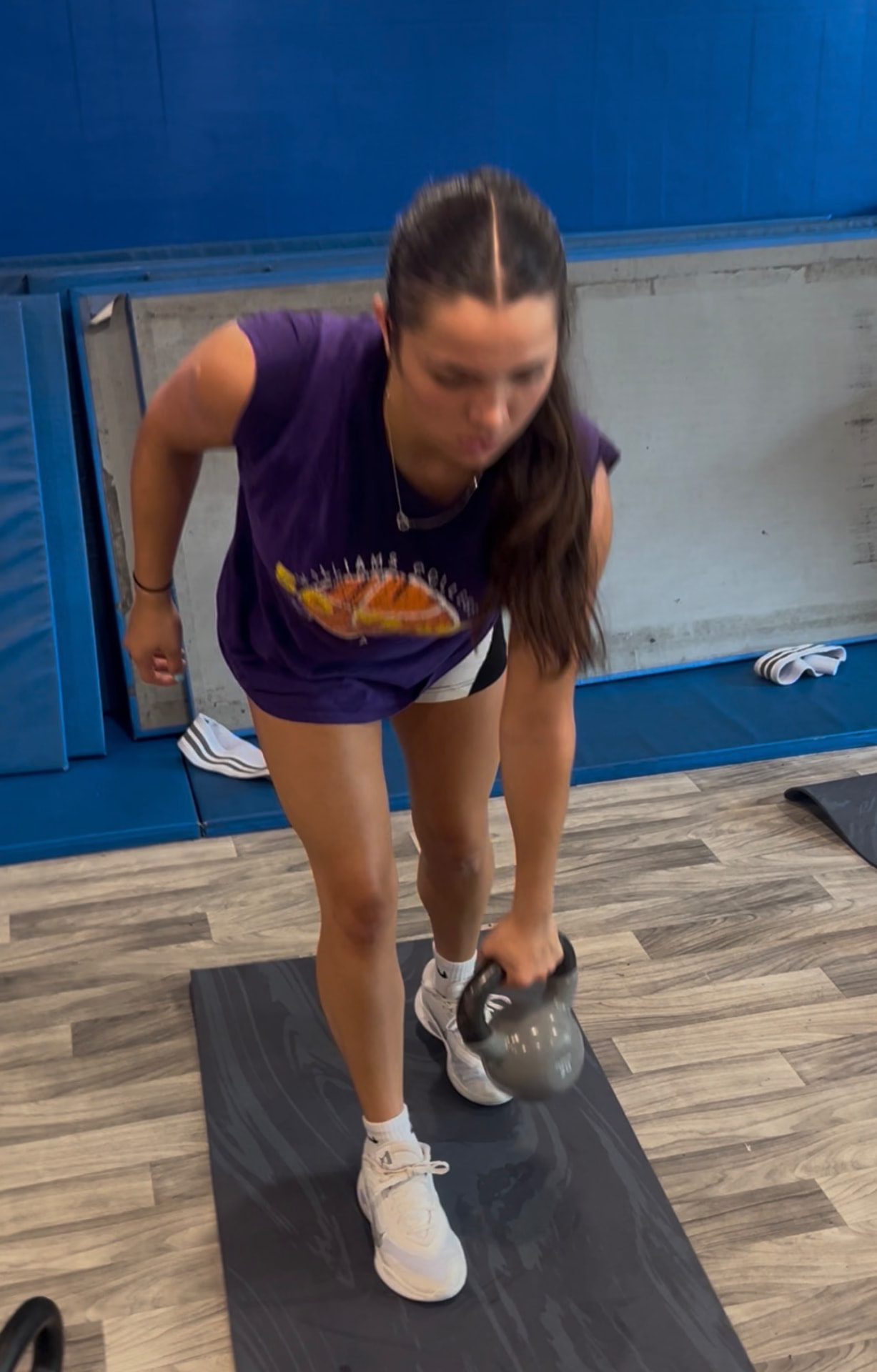 Athlete performing a single-arm kettlebell deadlift